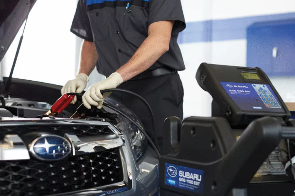 Close-up of hands connecting new battery terminals in a Subaru