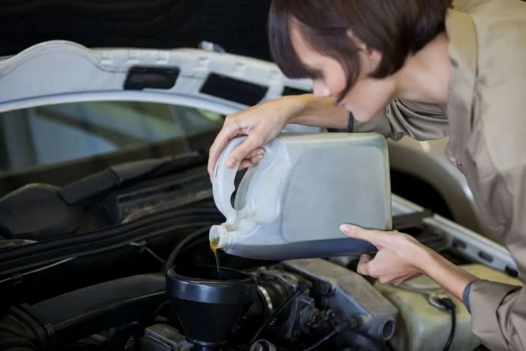 Experienced mechanic performing a battery replacement on a Maserati luxury car